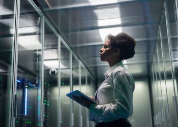 female technician working tablet data center
