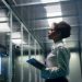 female technician working tablet data center