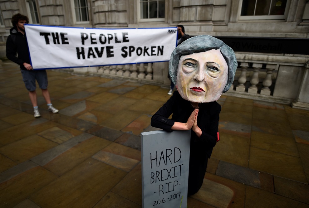 protestor wearing a theresa may mask is seen the day after britain's election in london