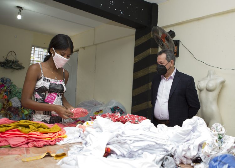 Porfirio Peralta observa a una empleada hacer su trabajo.