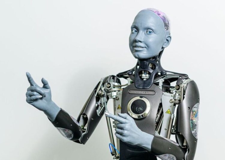 Ameca tiene una cara humana gris, puede girar la cabeza, tiene un cerebro transparente que se ilumina y puede responder y contestar preguntas.